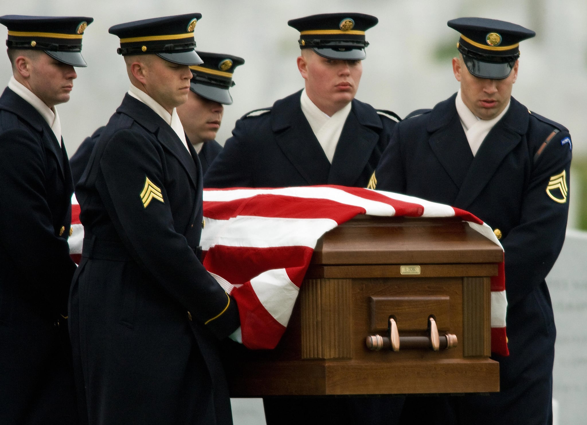 A US Army Honor Guard Casket Team carry the body of US Army Cpl. during funeral services in Arlington National Cemetery. A US Army Honor Guard Casket Team carry the body of US Army Cpl. during funeral services in Arlington National Cemetery.