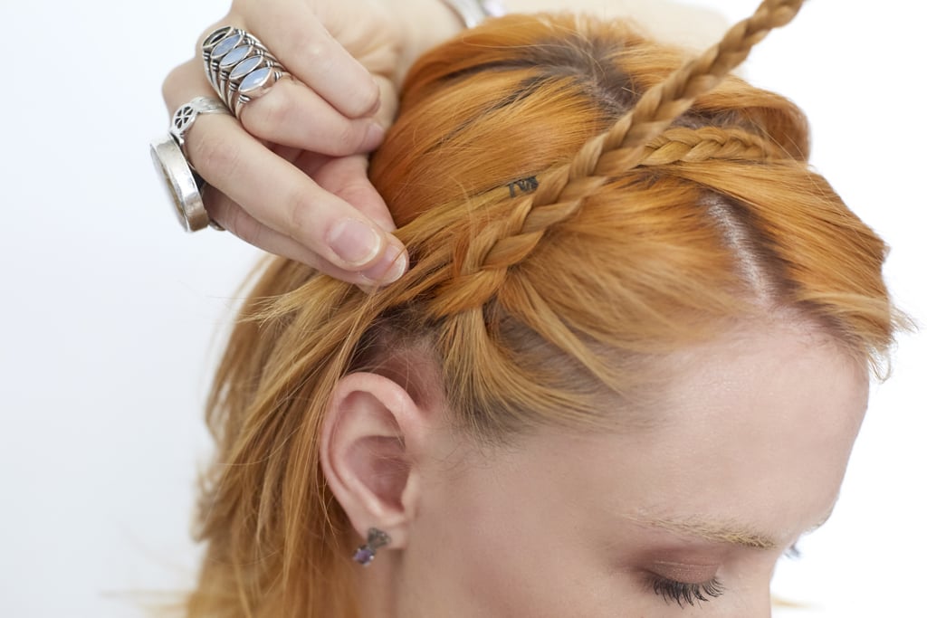 While holding first braid securely to your head, pull your second braid up and across the first one.