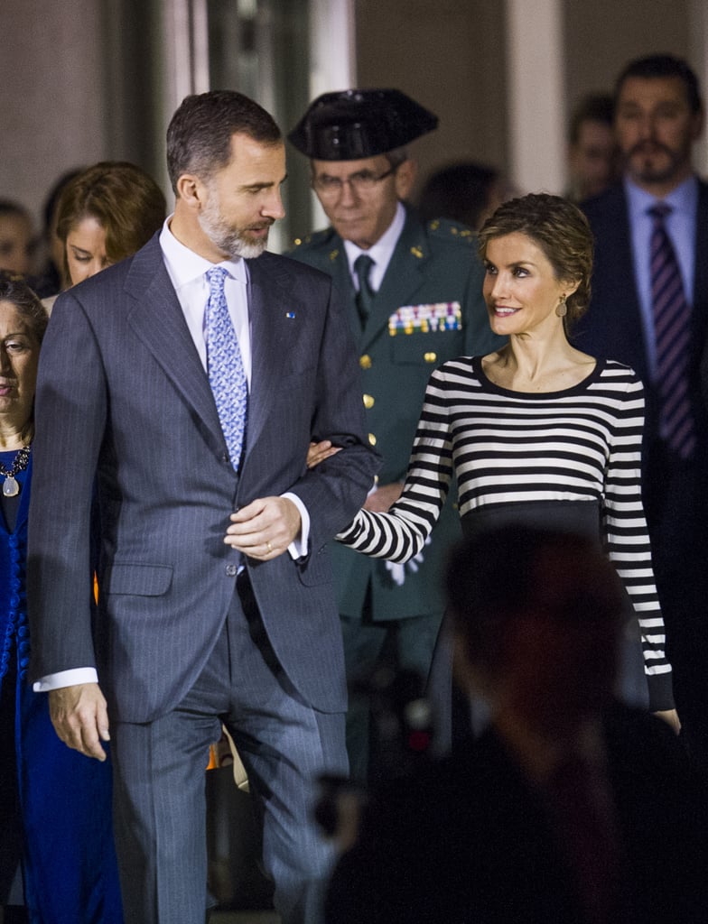 The king keeps Letizia close during a visit to an art museum.