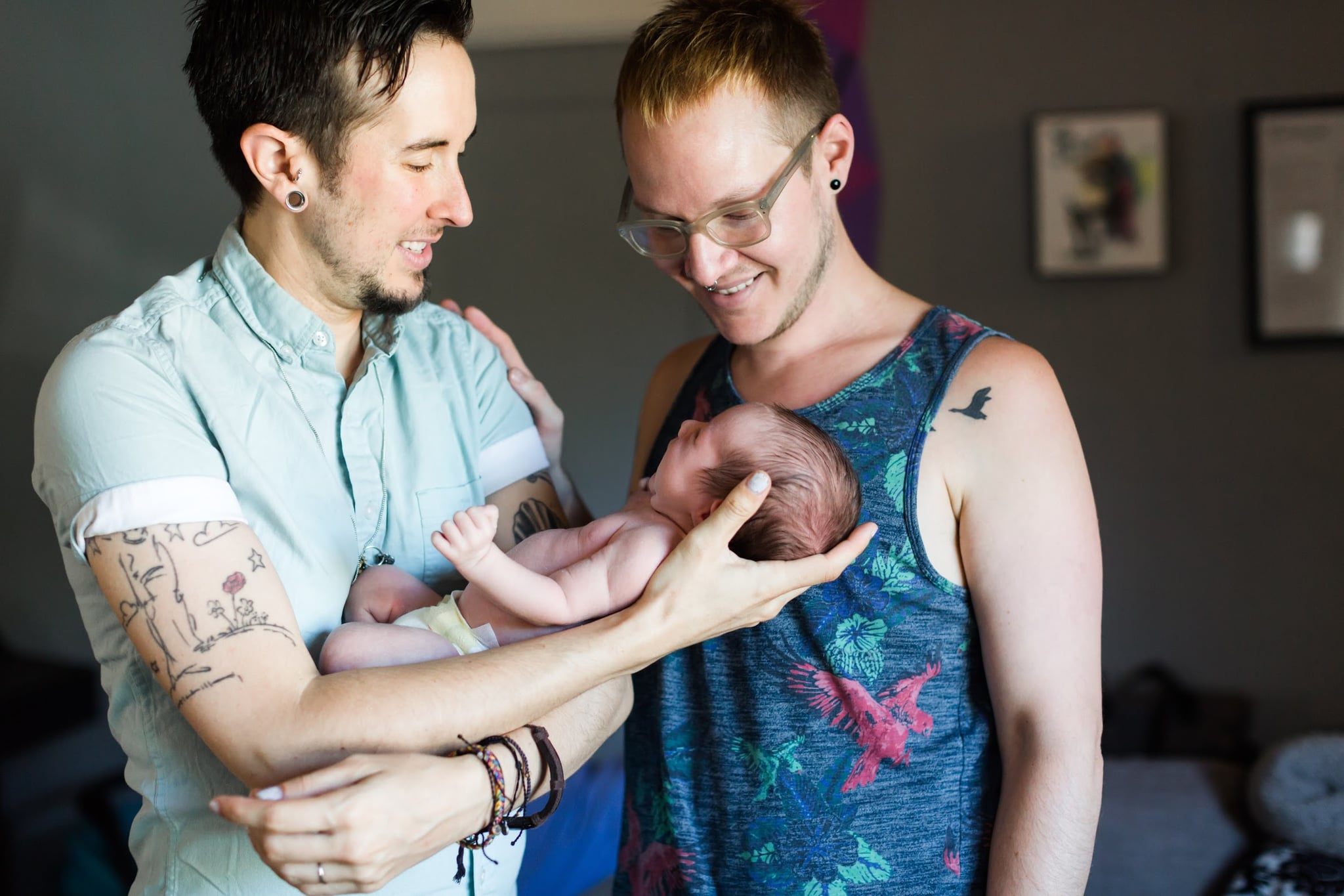 Biff & Trystan hold newborn Leo.