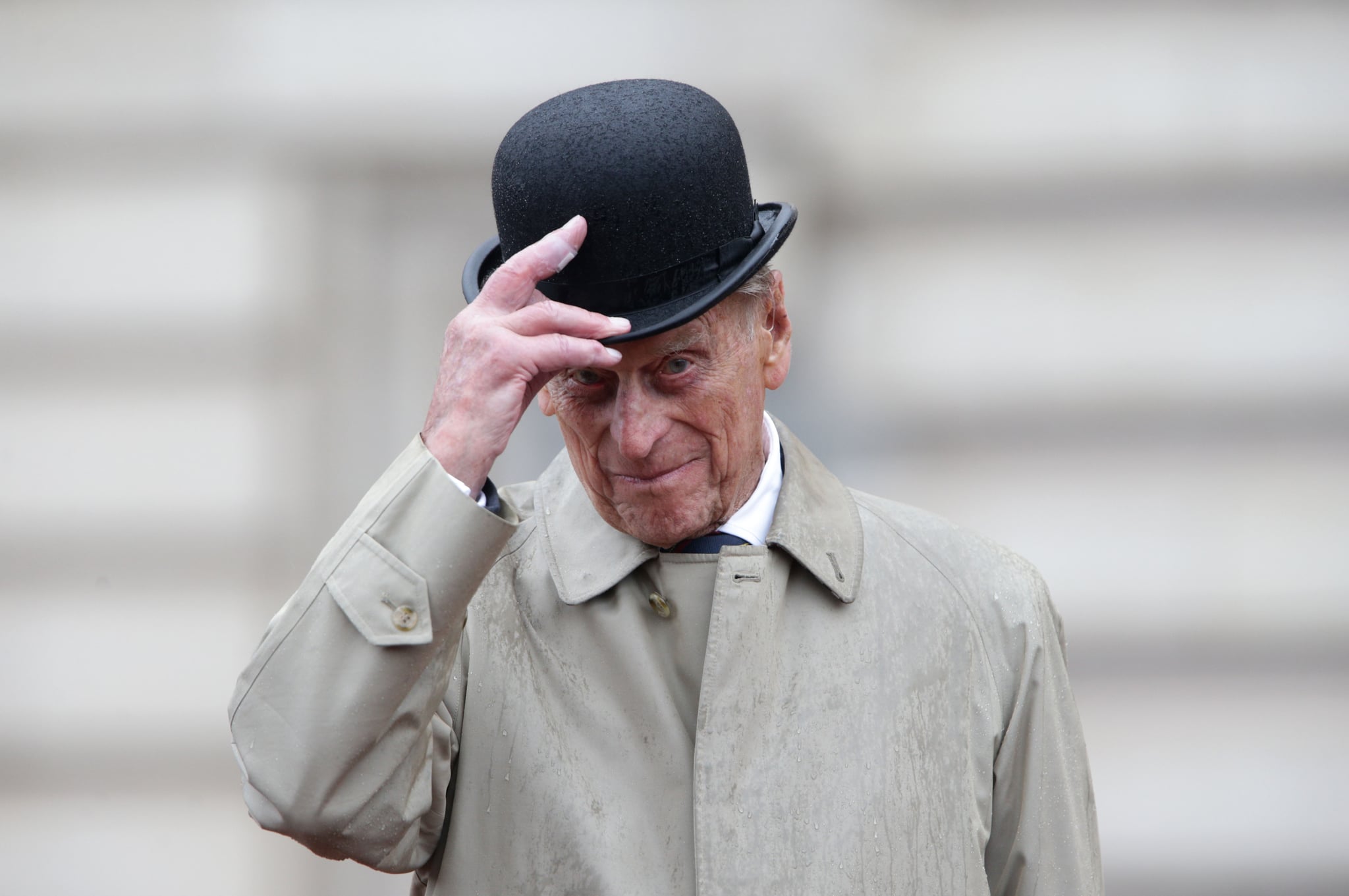 Britain's Prince Philip, Duke of Edinburgh, in his role as Captain General, Royal Marines, attends a Parade to mark the finale of the 1664 Global Challenge on the Buckingham Palace Forecourt in central London on August 2, 2017.  Prince Philip, the 96-year-old husband of Queen Elizabeth II, conducted his final solo public engagement on August 2, 2017, overseeing a military parade in the pouring rain before retiring from a lifetime of service. The Duke of Edinburgh, wearing a raincoat and bowler hat, met members of the Royal Marines and veterans -- many younger than him -- before taking the salute in the forecourt of Buckingham Palace. / AFP PHOTO / POOL / Yui Mok        (Photo credit should read YUI MOK/AFP/Getty Images)