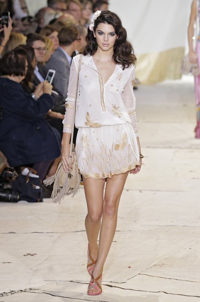 Kendall showed her girlie side at Diane von Furstenburg when she strutted down the runway in a flower- and butterfly-adorned white dress and matching hairpiece.