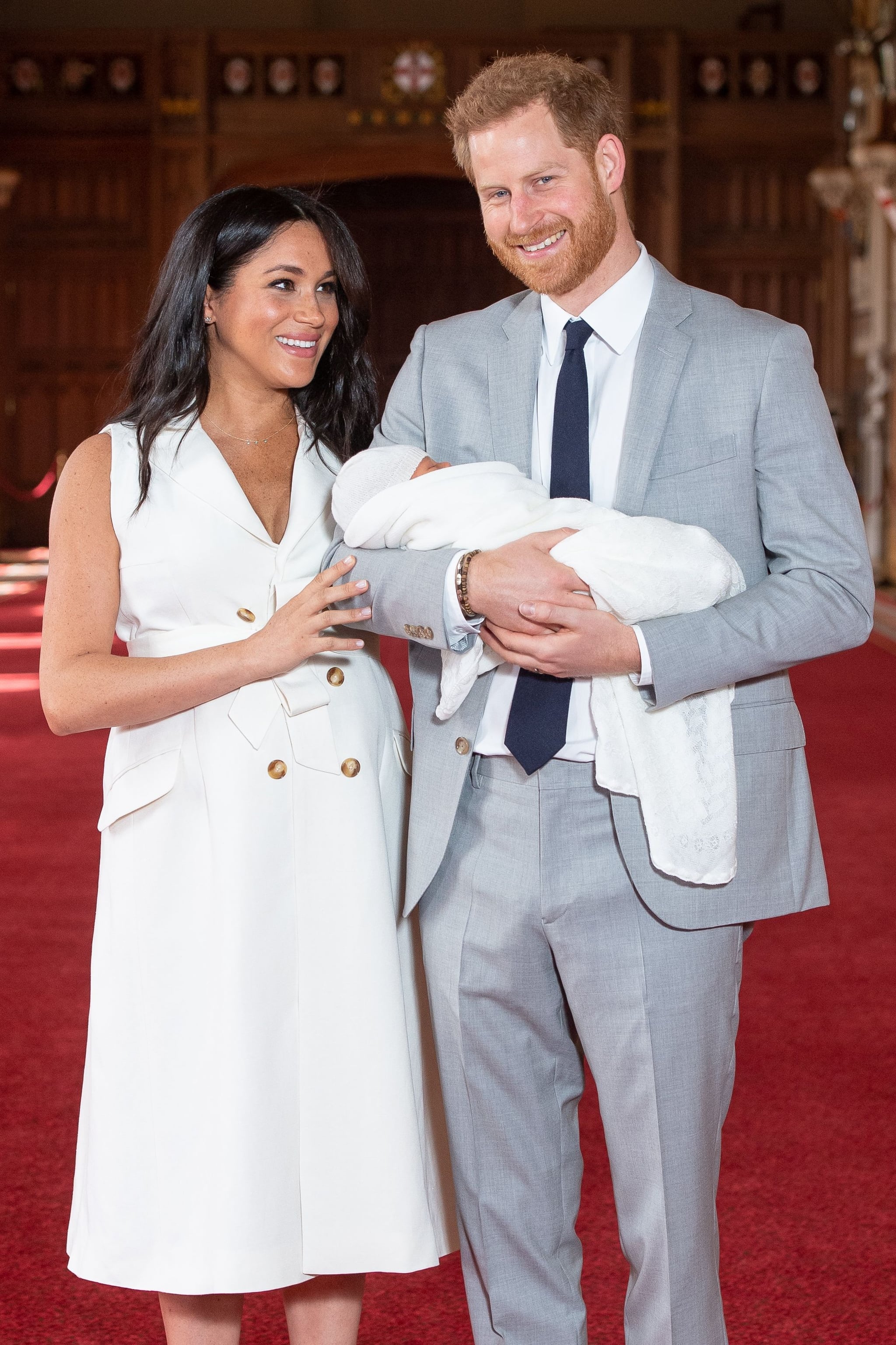 Britain's Prince Harry, Duke of Sussex (R), and his wife Meghan, Duchess of Sussex, pose for a photo with their newborn baby son, Archie Harrison Mountbatten-Windsor, in St George's Hall at Windsor Castle in Windsor, west of London on May 8, 2019. (Photo by Dominic Lipinski / POOL / AFP)        (Photo credit should read DOMINIC LIPINSKI/AFP/Getty Images)