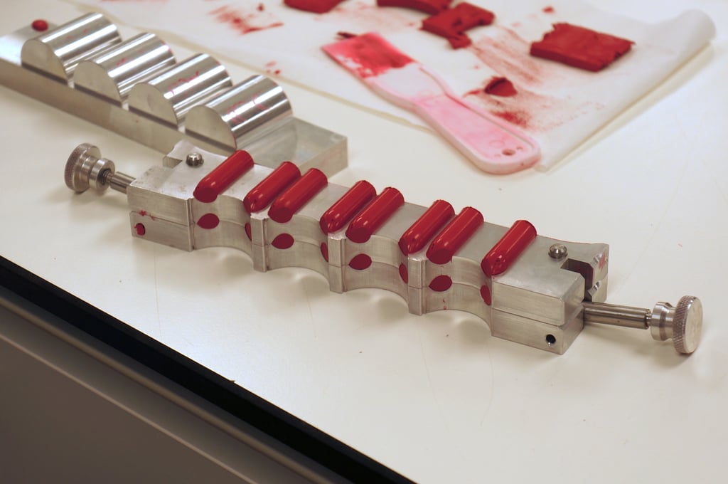 Gentle hands are needed to slowly remove the different sections of the metal mould to reveal all those perfectly shiny lipstick bullets.