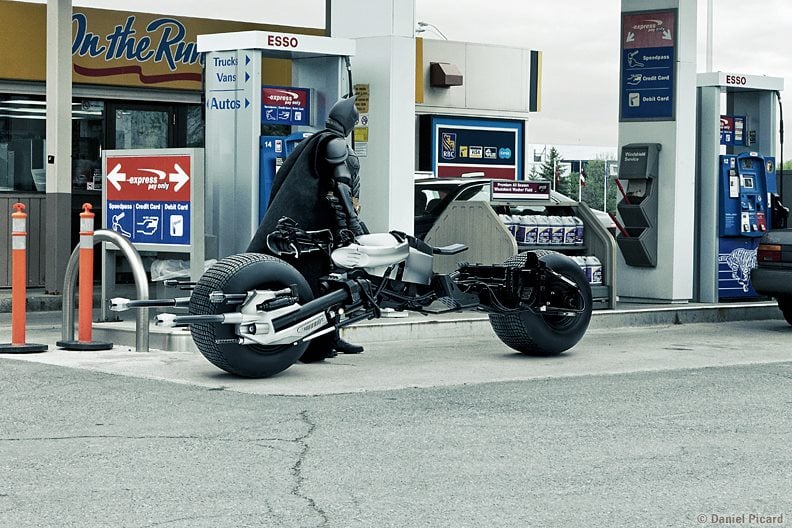 Batman pumps his own gas — guess he doesn't live in Oregon or New Jersey!