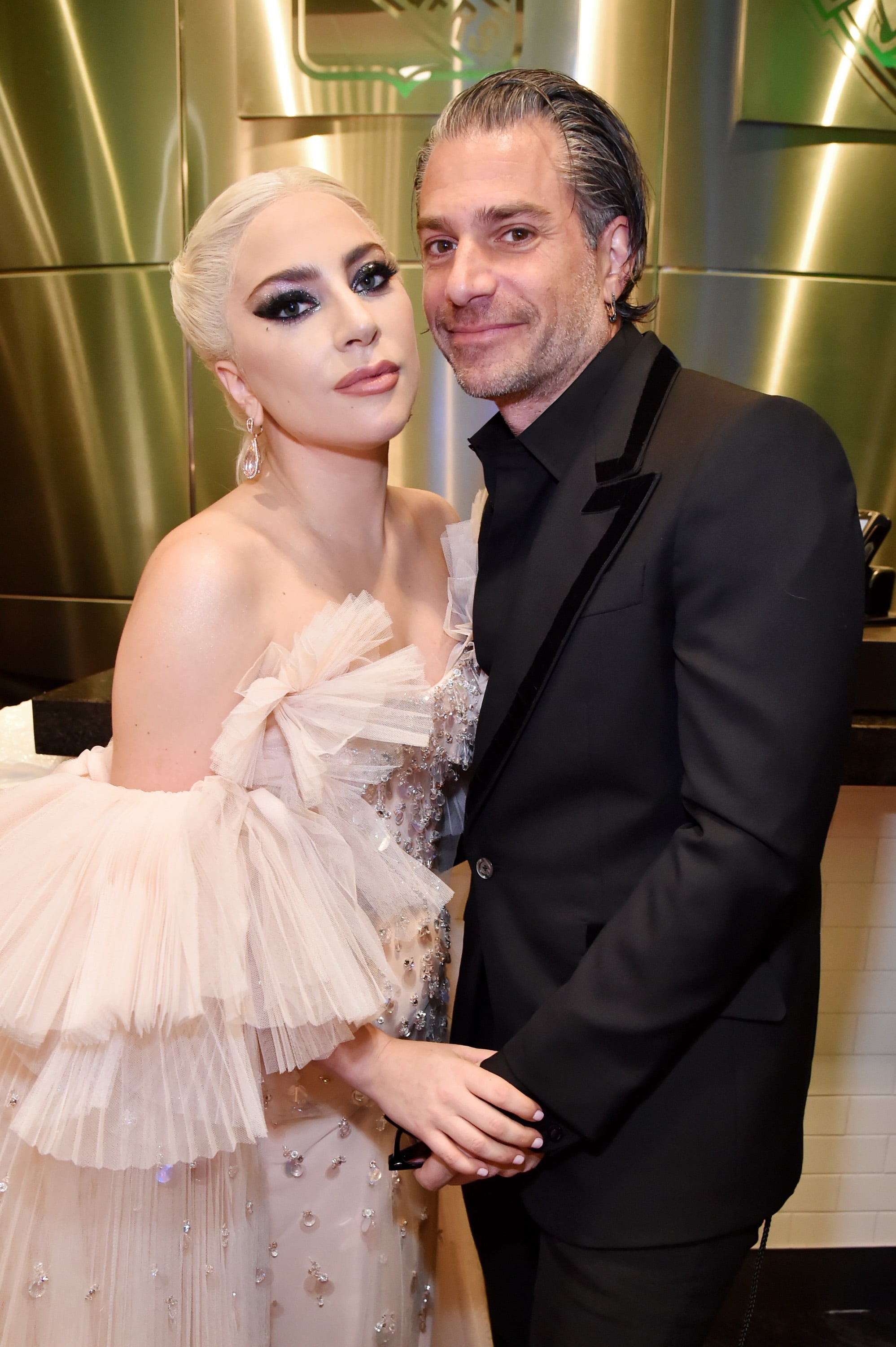 NEW YORK, NY - JANUARY 28:  Recording artist Lady Gaga and agent Christian Carino embrace backstage at the 60th Annual GRAMMY Awards at Madison Square Garden on January 28, 2018 in New York City.  (Photo by Kevin Mazur/Getty Images for NARAS)