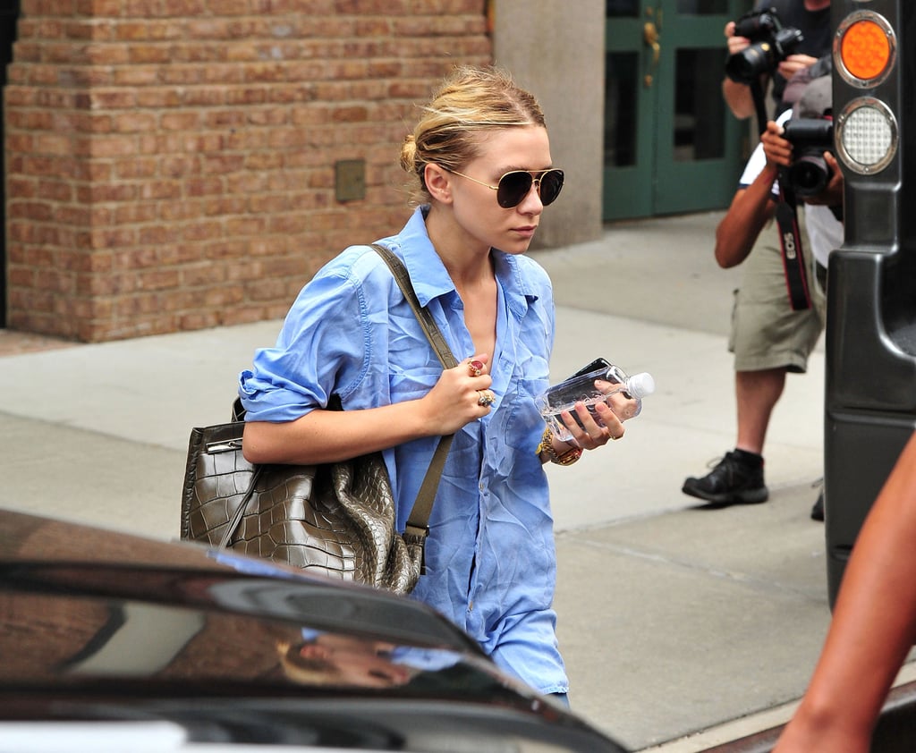 Ashley wore a pair with a blue button-down and olive animal textured backpack in NYC in 2011.