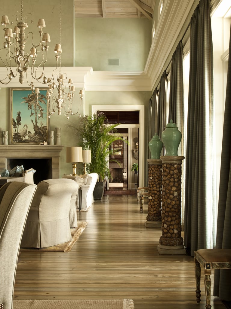 Natural light floods the living room, which overlooks the outside covered terraces and riverfront.