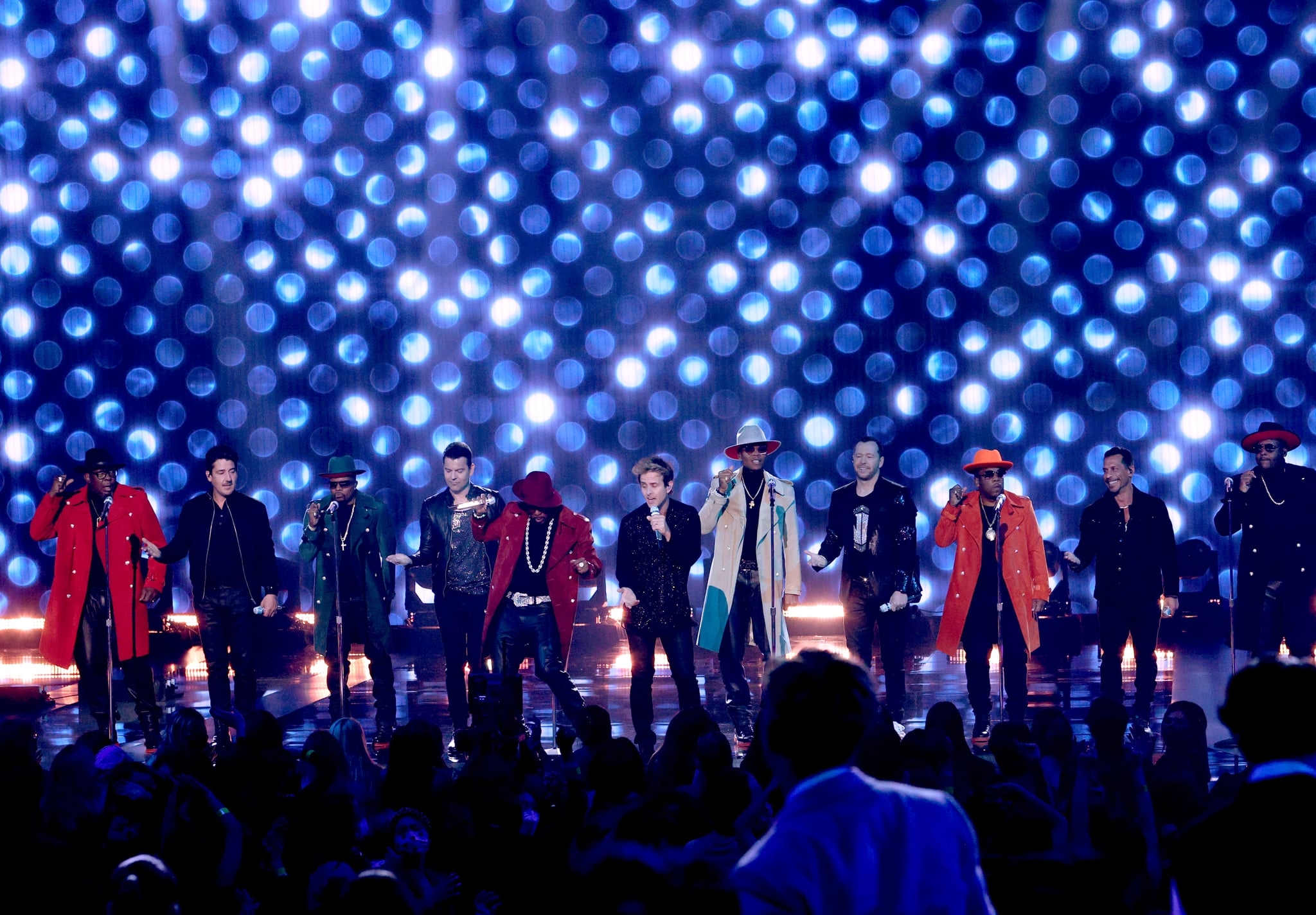 LOS ANGELES, CALIFORNIA - NOVEMBER 21:  (L-R) Bobby Brown of New Edition, Jonathan Knight of New Kids On The Block (NKOTB), Ricky Bell of New Edition, Jordan Knight of NKOTB, Ralph Tresvant of New Edition, Joey McIntyre of NKOTB, Ronnie DeVoe of New Edition, Donnie Wahlberg of NKOTB, Michael Bivins of New Edition, Danny Wood of NKOTB, and Johnny Gill of New Edition perform onstage during the 2021 American Music Awards at Microsoft Theater on November 21, 2021 in Los Angeles, California. (Photo by Kevin Winter/Getty Images for MRC)