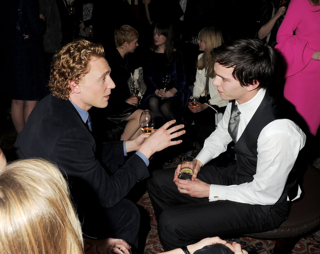 Tom Hiddleston was in a deep conversation with Nicholas Hoult at a Mulberry dinner in London in February 2012.