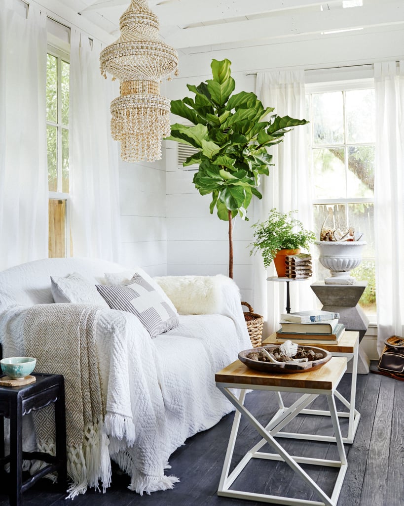 Throwing a large white bedspread over the sofa lends a bohemian vibe but can also cover up a dated piece of furniture.
Source: Cody Ulrich via Homepolish