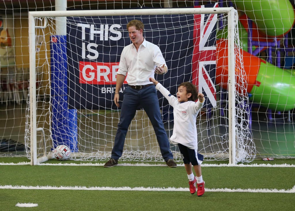 Prince Harry played soccer with a young boy during his tour of Brazil on Tuesday.