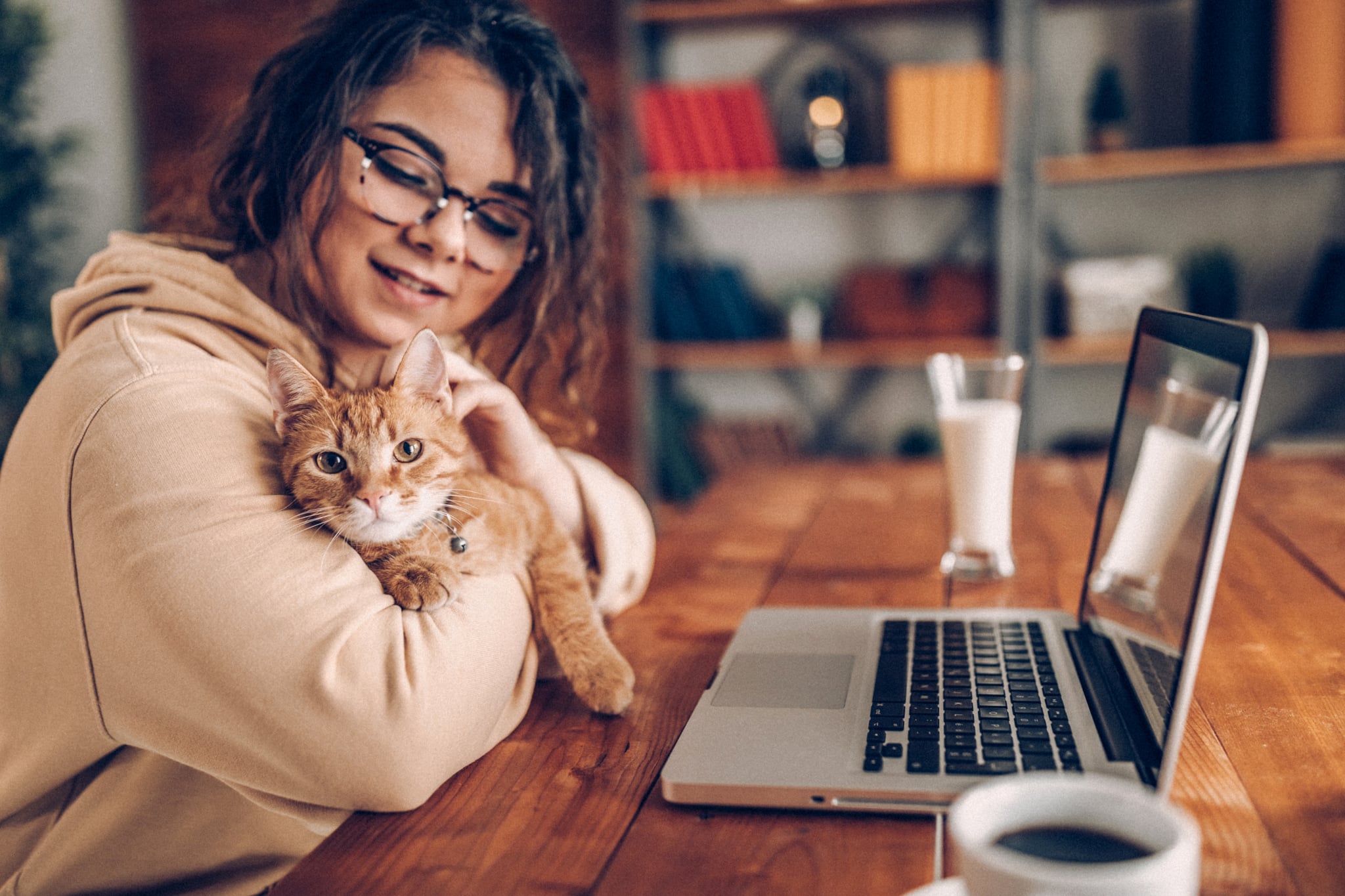 Woman with cat working from home