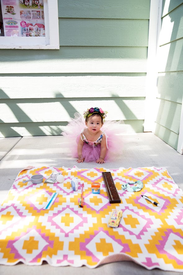 This sweet birthday party included a fun game that is a Chinese tradition. People pick items that relate to certain professions and whatever the baby picks will determine their future! How cute! For example, a ball would mean an athlete, an abacus means a mathematician, a necklace could mean a fashion designer, etc. This little birthday girl? She picked the ball, which she quickly dropped and then proceeded to pick up some money. Smart girl!