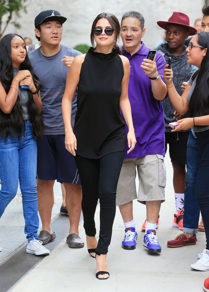 Nothing is more practical for a day of press in the city than black skinny jeans, a sleveless top, and strappy sandals — it's classic all around.