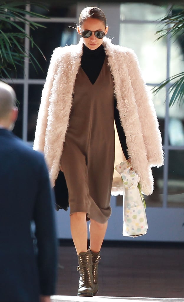 Nicole opted for a black and brown ensemble beneath her coat.