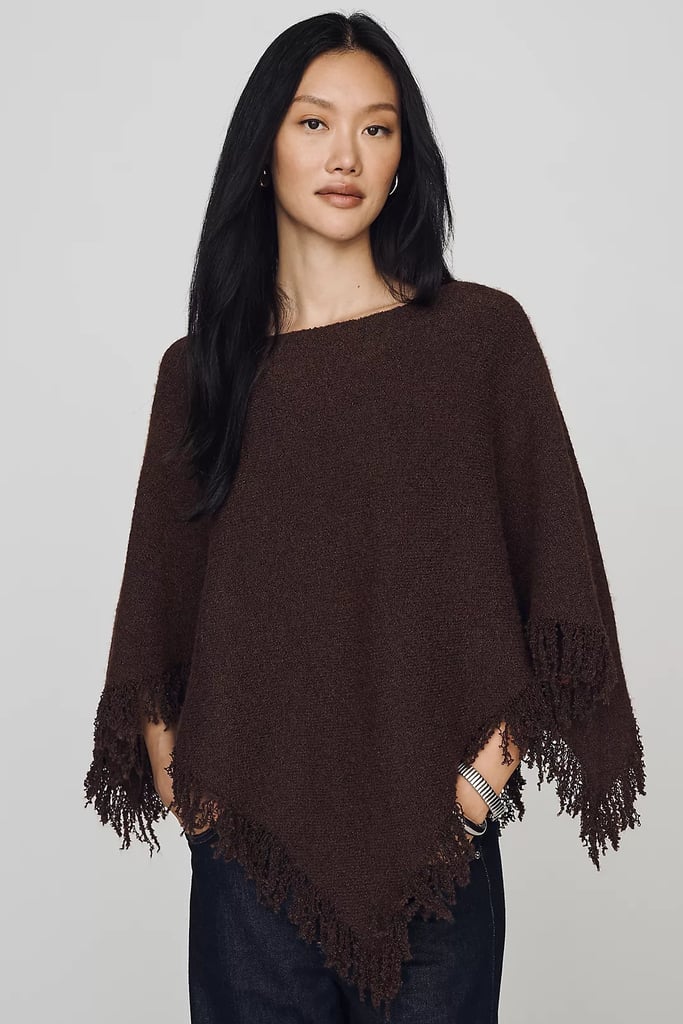 By Anthropologie Knit Fringe Triangle Poncho ($118)
Sheer ponchos and capes were everywhere this summer. I mean, who doesn't love the breathability of the style? If you aren't ready to say goodbye to the trend, add this knitted version to your cart. It has a bit more weight for cooler weather and a fringe trim for an added flair.