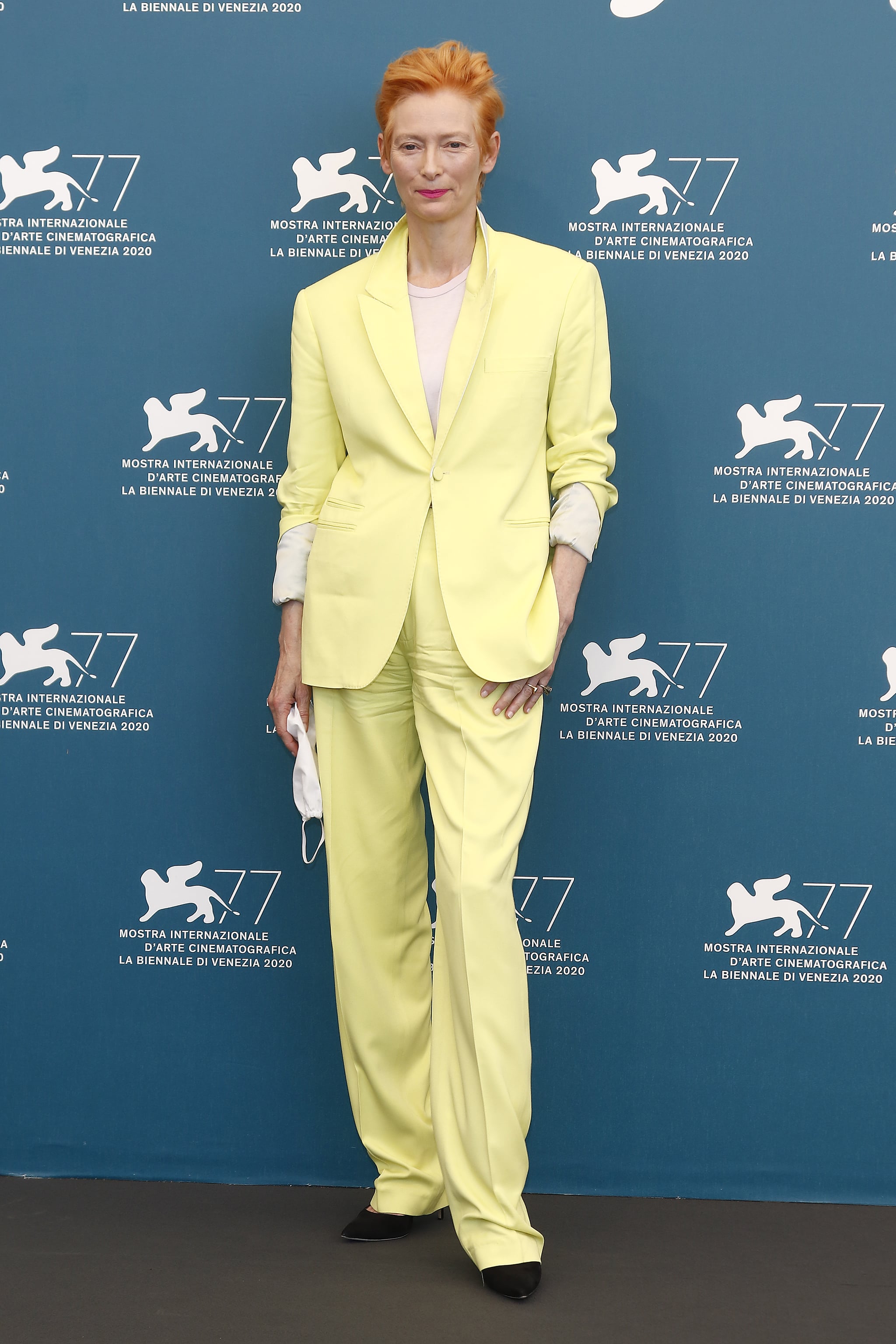 Tilda Swinton wore a citrus-coloured suit to the photocall for The Human Voice.