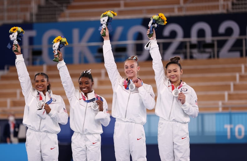 TOKYO, JAPAN - JULY 27: Jordan Chiles, Simone Biles, Grace McCallum and Sunisa Lee of Team United States react on the podium after winning the silver medal during the Women's Team Final on day four of the Tokyo 2020 Olympic Games at Ariake Gymnastics Cent