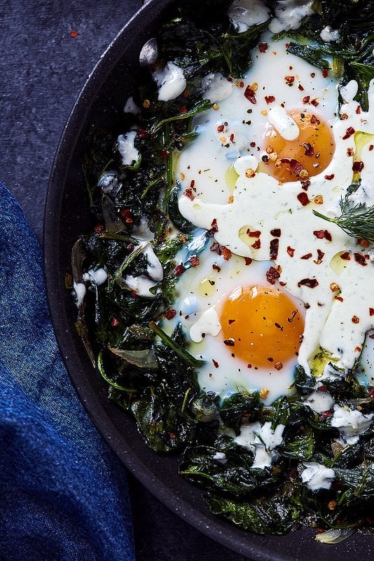 Skillet Baked Eggs With Greens and Feta Yogurt Drizzle