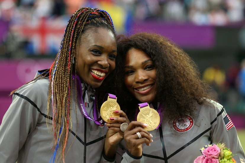 LONDON, ENGLAND - AUGUST 05:  Gold medalists Serena Williams of the United States and Venus Williams of the United States celebrate during the medal ceremony for the Women's Doubles Tennis on Day 9 of the London 2012 Olympic Games at the All England Lawn 