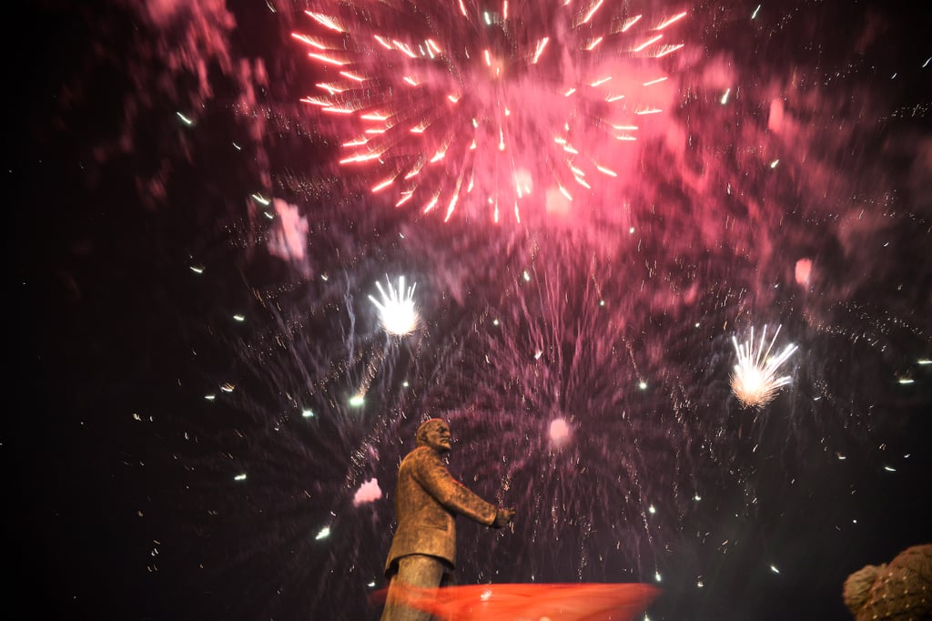 Fireworks exploded behind the monument of Soviet Union founder Vladimir Lenin in the Crimean capital of Simferopol Sunday night, after preliminary results showed a landslide for the pro-Russia side.