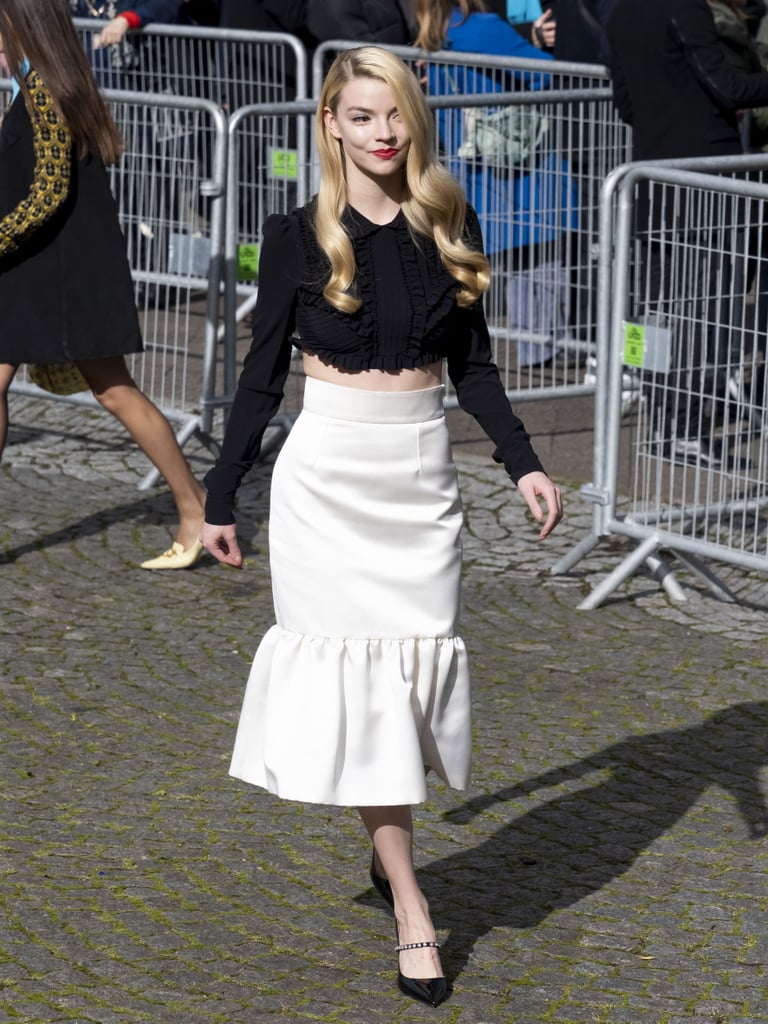 Anya was spotted during Paris Fashion Week's fall 2021 season in head-to-toe Miu Miu outside of the show. She teamed a Victorian-inspired crop top with a fluted skirt and embellished patent pumps.