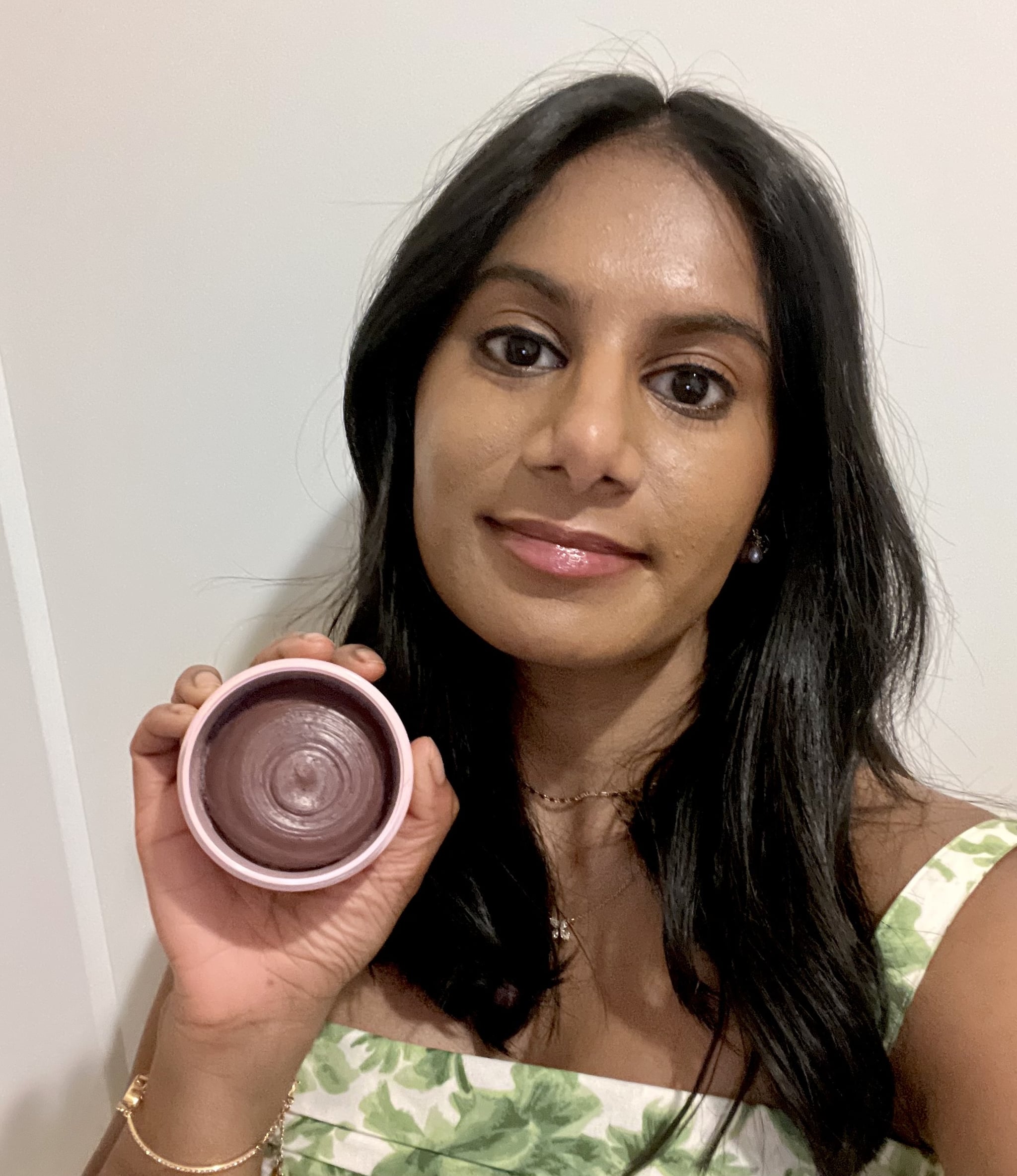 Woman holding the Shaz & Kiks Unearth Yourself Balancing Clay Hair Cleanser Shampoo.