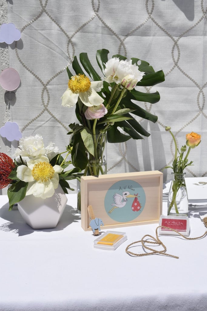 Photography: Breelyn Stone // Invitations and Signage: Kirra Reyna Designs // Furniture: Cost Plus World Market // Peacock Chair: Cost Plus World Market  // Cloud Mobile: Polly Chrome Crafts // Catering: Chick-Fil-A // Fruit and Fresh Coconuts: Melissa's Produce // Desserts: Susie Cakes // DIY Onesie Decorating Kit: A lil' Moore // Candy: Sugarfina // Marshmallow Treats: Bliss & Baker // Mom's Dress: A Pea in the Pod // Favors: Aden + Anais, California Baby