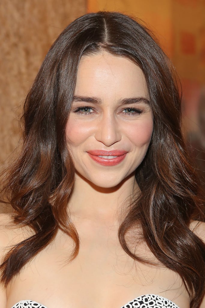 "When I'm working with younger actresses, it's always nice to keep them clean and fresh, so their own features show up and are not muted out," Chanel makeup artist Jillian Dempsey said. "I wanted to keep her effortless-looking. Emilia has beautiful porcelain skin, so I didn't really need to cake on a ton of foundation or powder." So Dempsey just added a thin layer of Chanel Vitalumière Aqua Ultra-Light Skin Perfecting Sunscreen Makeup ($45).
To get her khaki-and-bronze eye makeup look, Dempsey outlined her peepers with Chanel Stylo Yeux Waterproof Long-Lasting Eyeliner in Khaki Précieux ($30), a khaki gold-green. She then layered on Chanel Limited Edition Quadra Eye Shadow in Séduction ($59). "I didn't do a traditional smoky eye, but I wanted her eyes to have a little drama — to look ethereal, and worn in, and dewy, and luminescent," Dempsey explained. Her lashes were finished with Chanel Inimitable Mascara ($30) and short-length individual lashes on three quarters of her eye. 
Emilia's lips were done up in Chanel Rouge Coco Hydrating Crème Lip Colour in Mystique ($34), a dusty rose color. "I like to apply a nude lip liner, like Chanel Le Crayon Lèvres Precision Lip Definer ($29), after I put on the color so it doesn't look too perfect," said Dempsey. "I call it my 'scribbling method': You put on your lipstick color with a brush, so it looks like you're staining the lips at first. Then you take your liner, and you push out on the upper corners of the mouth to build a shelf where you want the color to go, moving with the natural shape of the lips. Then you go back in with your lip color."