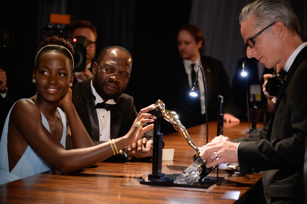Lupita and her dad looked at her award.