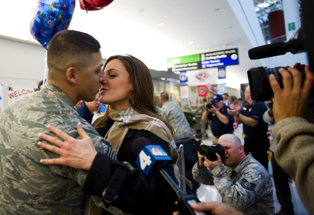 A couple shared a not-so-private kiss upon the return home of the 300 Airmen, the last Air Force personnel from Iraq, at Baltimore Washington International Airport in Baltimore on Dec. 20, 2011.