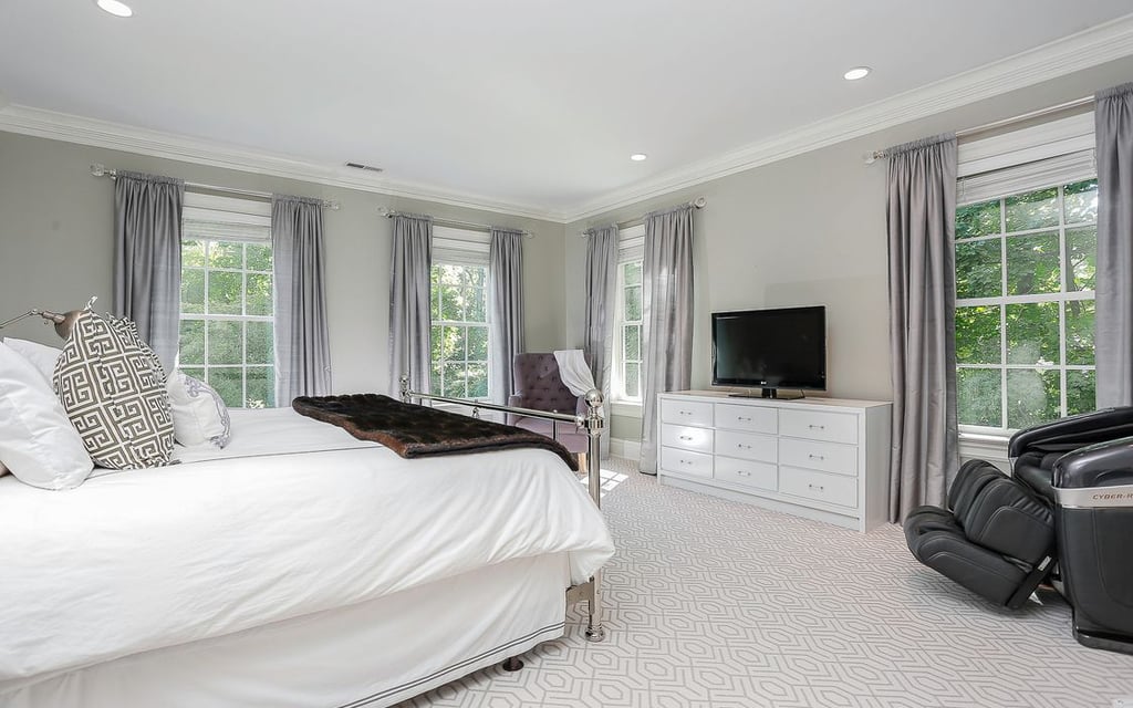 The bedroom has a soothing, cool gray color palette.