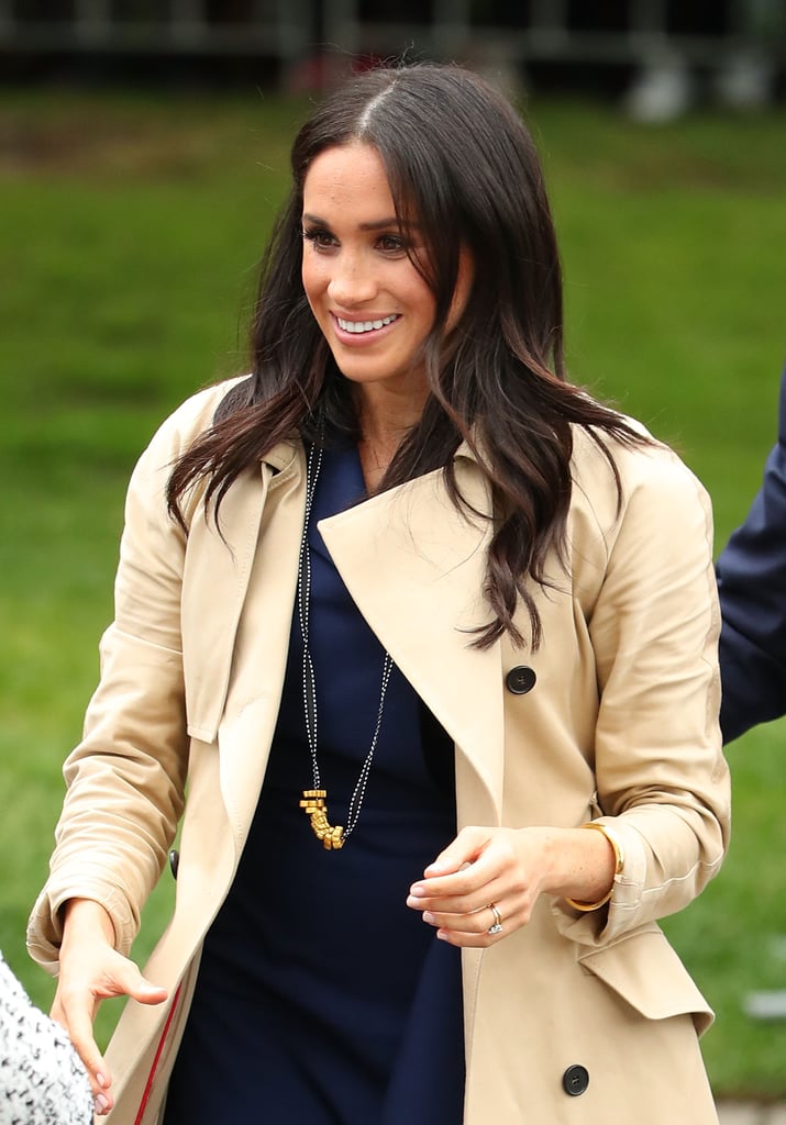 Meghan received a gold painted pasta necklace from a boy named Gavin during an appearance, which she gratefully accepted and wore proudly.