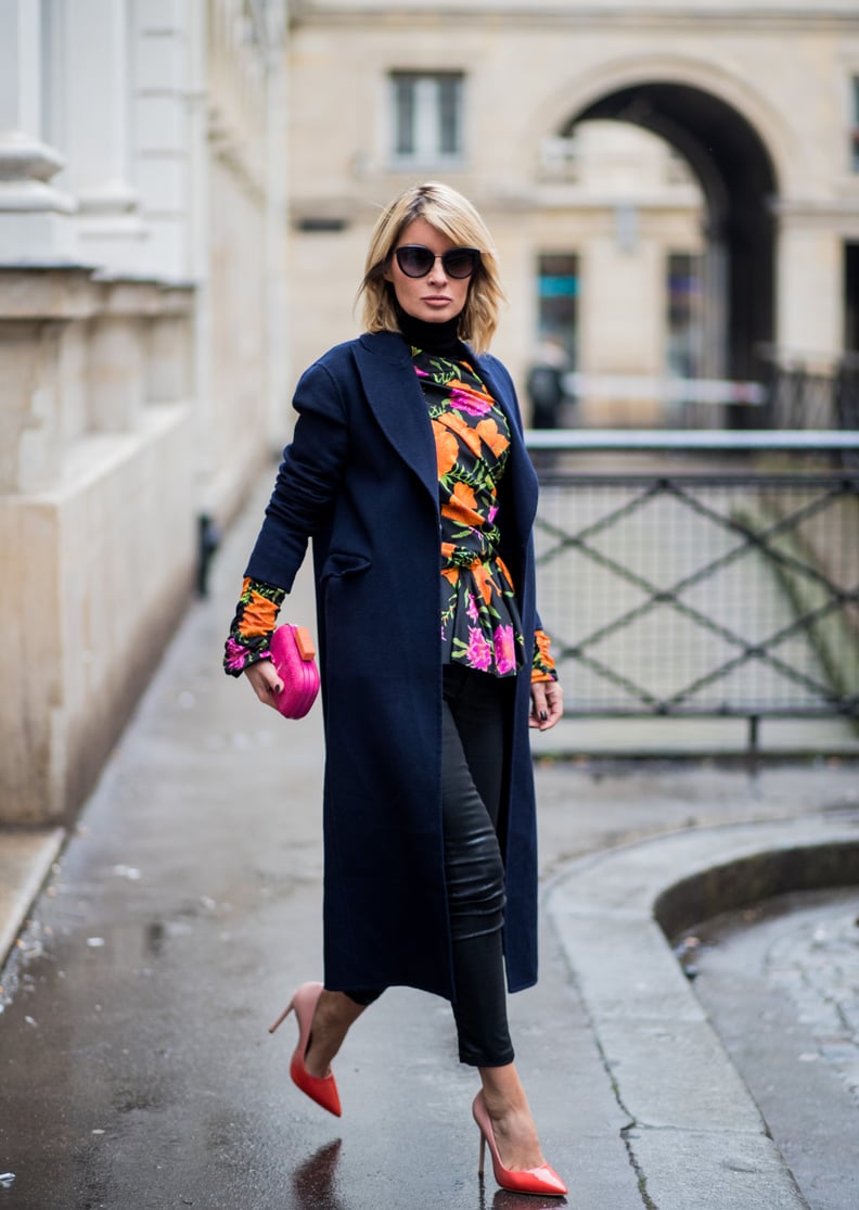 With a Floral Patterned Top, a Long Navy Coat, and Leather Pumps