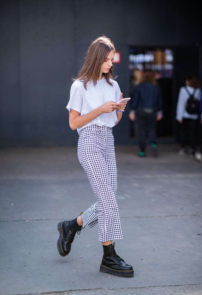 Channel the '90s with a white tee, checked pants, and lug-sole combat boots.