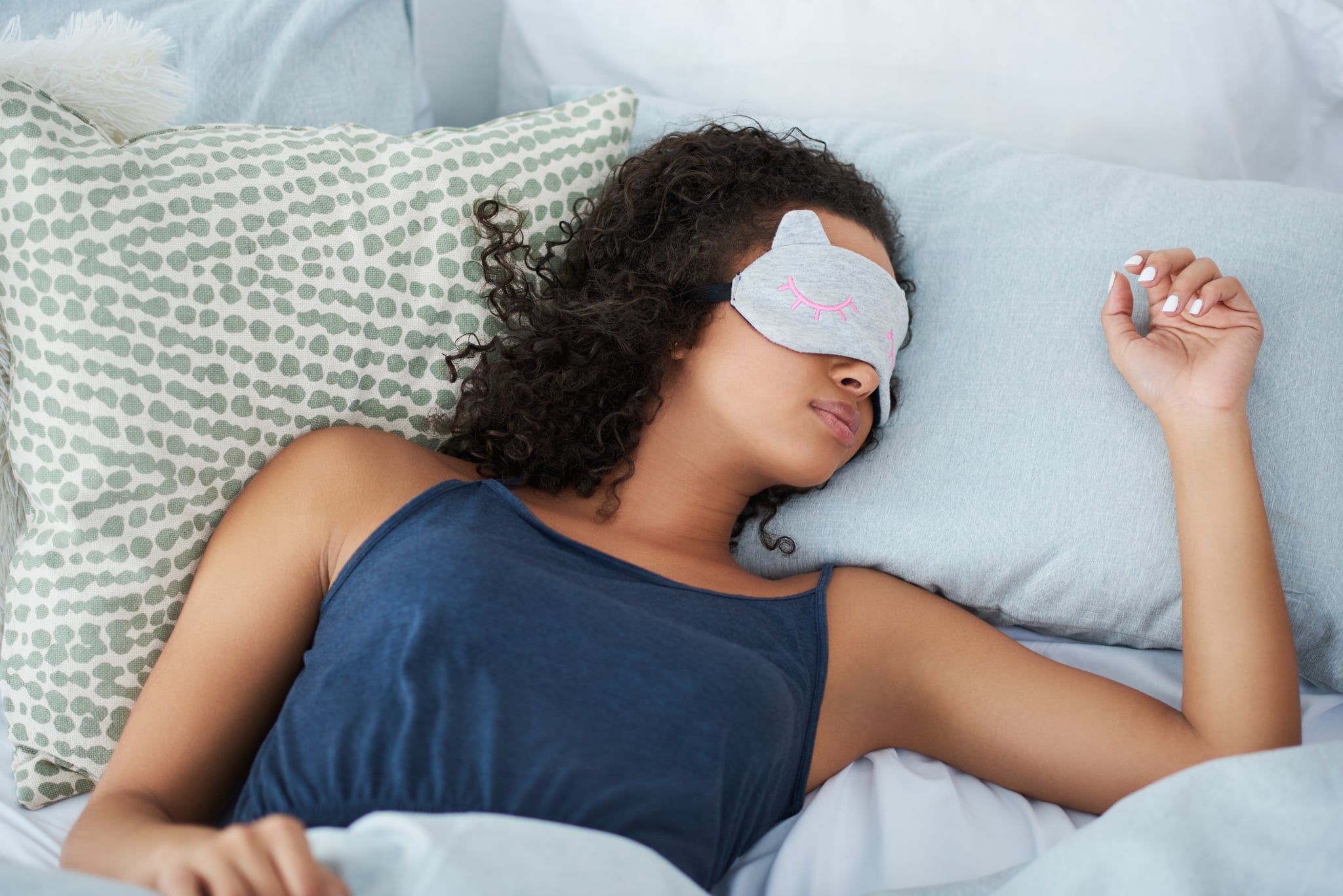 Shot of an attractive young woman sleeping in bed with an eye mask during the morning