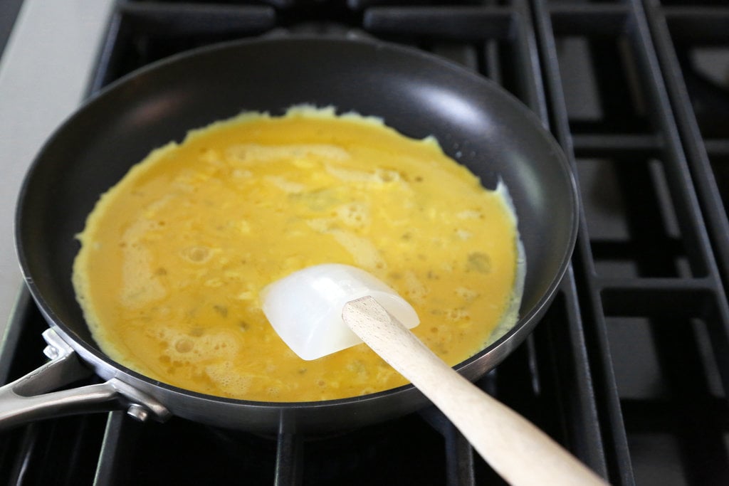 Whisk with one hand and shake the pan vigorously with the other.