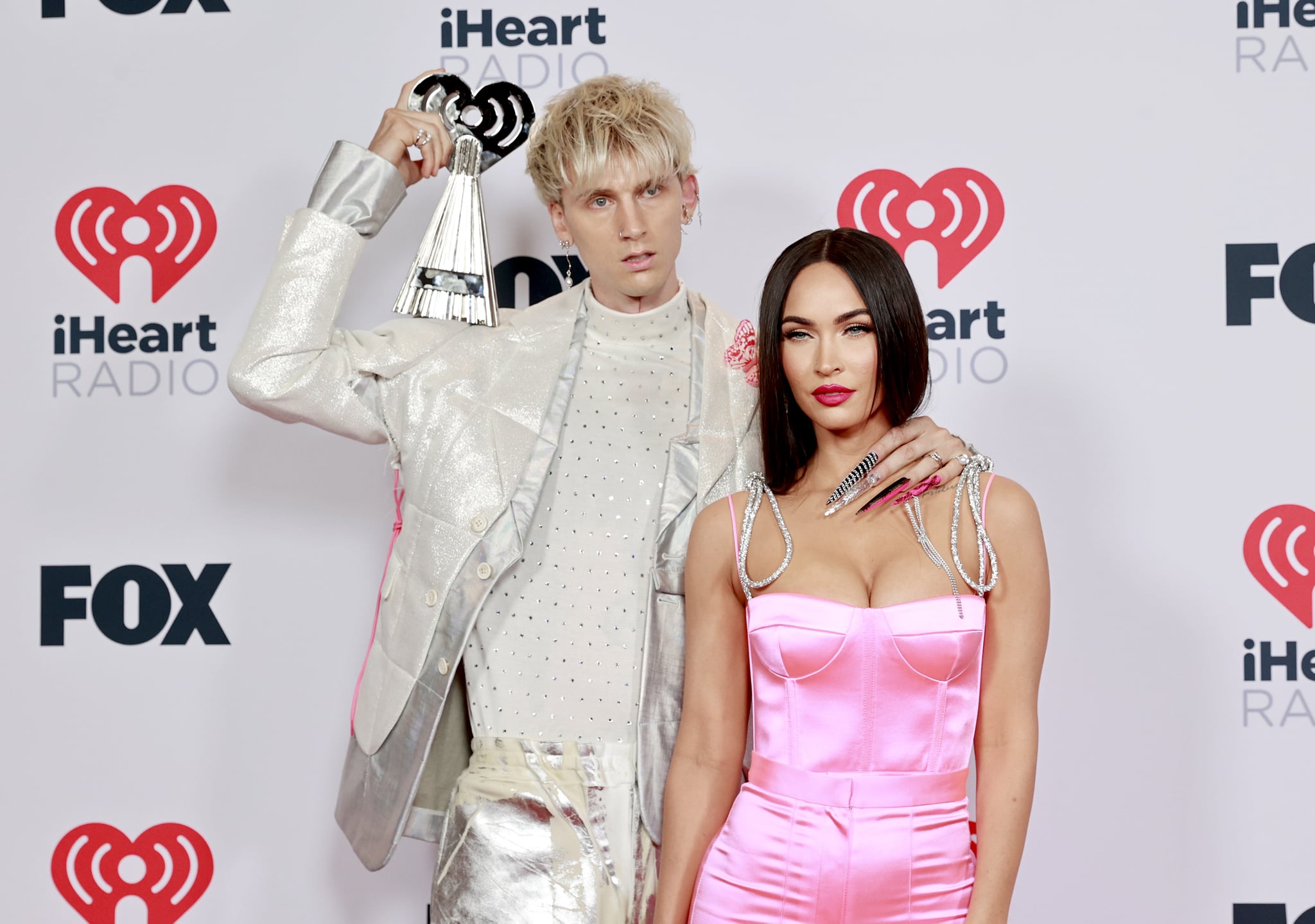 LOS ANGELES, CALIFORNIA - MAY 27: (EDITORIAL USE ONLY) (L-R) Machine Gun Kelly, winner of the Alternative Rock Album of the Year award for 'Tickets To My Downfall,' and Megan Fox attend the 2021 iHeartRadio Music Awards at The Dolby Theatre in Los Angeles, California, which was broadcast live on FOX on May 27, 2021. (Photo by Emma McIntyre/Getty Images for iHeartMedia)