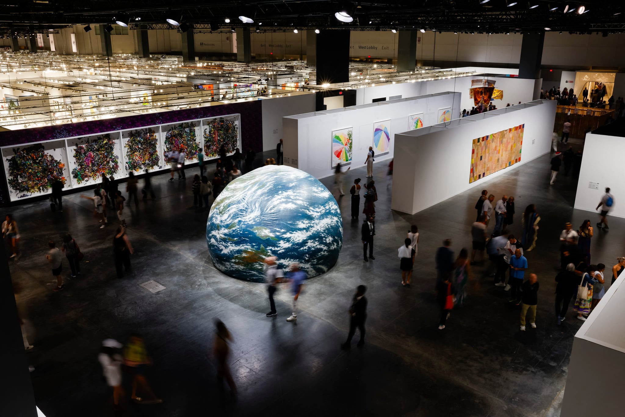 visitors walking throughout the Miami Beach Convention Center during Art Basel