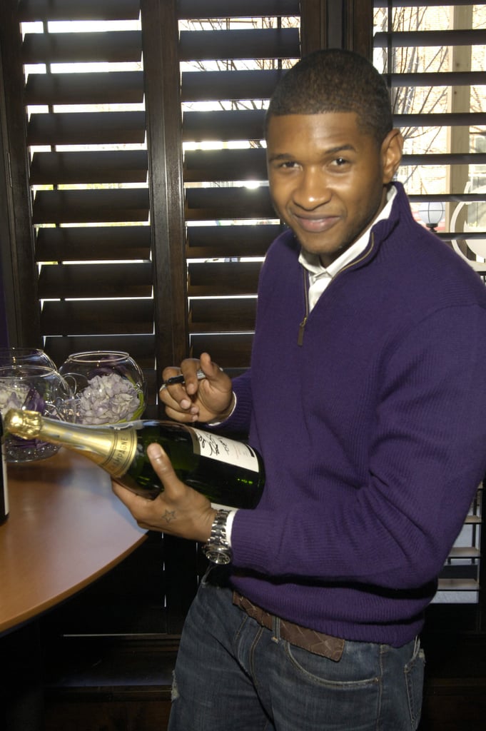 Usher signed bottles of Champagne during an Atlanta luncheon in December 2006.