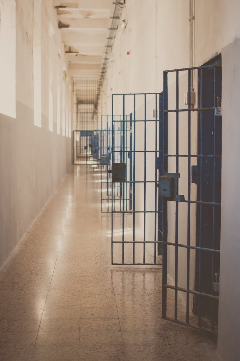 Corridor of an abandoned prison ward in Island Isonara (Isola Isonara) in Sardinia showing the cells blue doors opened