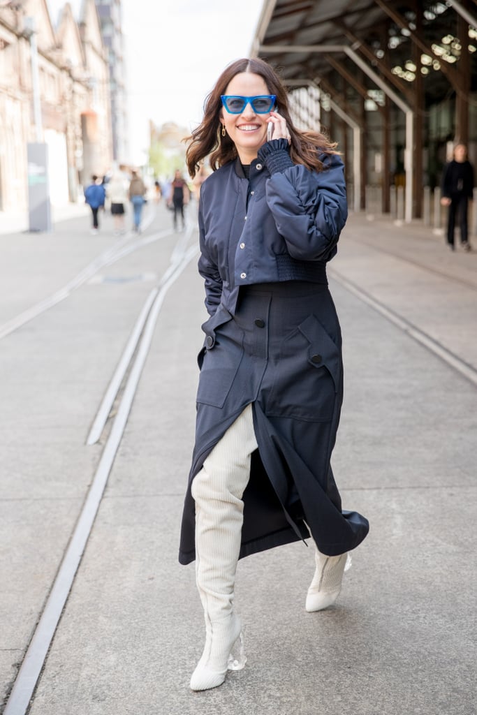 Neutral, thigh-high boots broke up this dark outfit.
