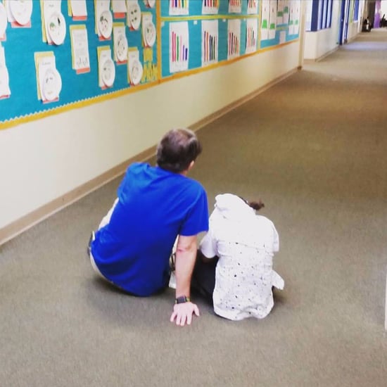 Teacher Comforting a Student on the Floor