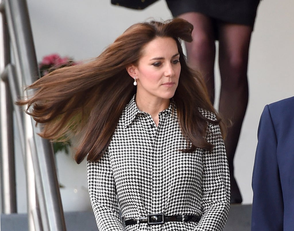 Kate's hair blew in the wind, showing off a pair of dainty pearl drop earrings.