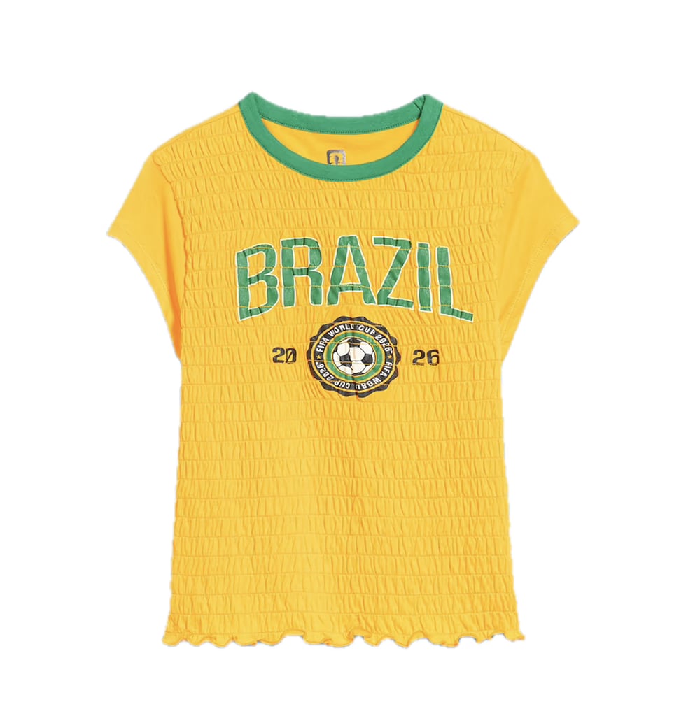 Old Navy FIFA World Cup 26 Smocked Graphic T-Shirt ($24, originally $35)
Calling all Y2K enthusiasts! Old Navy created this adorable smocked T-shirt across 13 different countries to bring a trendy spin to World Cup merch. From the colorful trim to the lightweight cotton fabric, this style can easily translate from the stadium to everyday streetwear.