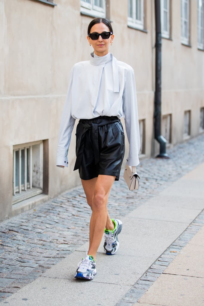 Try it all by styling a ladylike silk blouse with edgy leather shorts and sporty performance sneakers to boot.