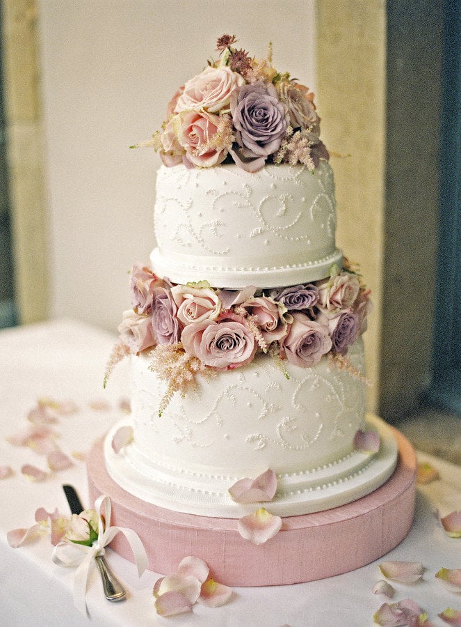 Maybe it's the purple and pink roses or elaborate design, but there's something so whimsical and lovely about this cake. 
Photo by Polly Alexandre Photography via Style Me Pretty