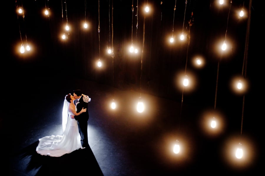 Speaking of lighting, for the couples who were really hoping for that outdoor and open-air reception, complete with bistro lighting, there's no reason not to string up lights inside as well. With bistro lights and market lighting becoming so popular, almost every rental company is offering them, and as long as your venue allows them, you should consider stringing them inside of your venue.