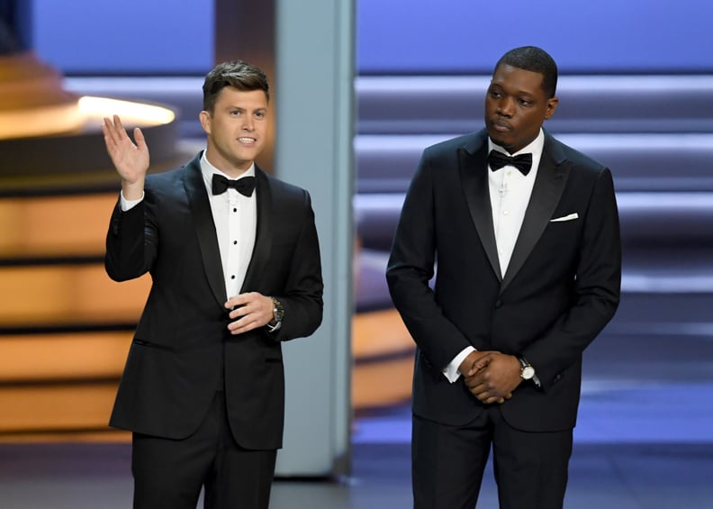LOS ANGELES, CA - SEPTEMBER 17:  Colin Jost (L) and Michael Che speak onstage during the 70th Emmy Awards at Microsoft Theater on September 17, 2018 in Los Angeles, California.  (Photo by Kevin Winter/Getty Images)